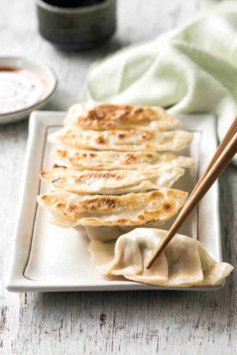 Pan-fried gyoza dumplings with chopsticks